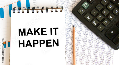 In the notebook, the text MAKE IT HAPPEN, next to the calculator and reports with graphs.