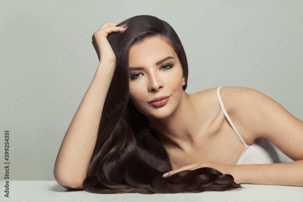 Beautiful brunette woman with long healthy shiny hair on white background Beautiful brunette woman with long healthy shiny hair on white background