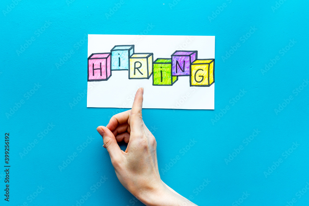 Hiring - job recruting concept. Word Hiring on paper banner, top view Hiring - job recruting concept. Word Hiring on paper banner, top view
