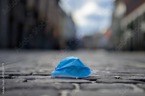 Discarded blue protective face mask photo
