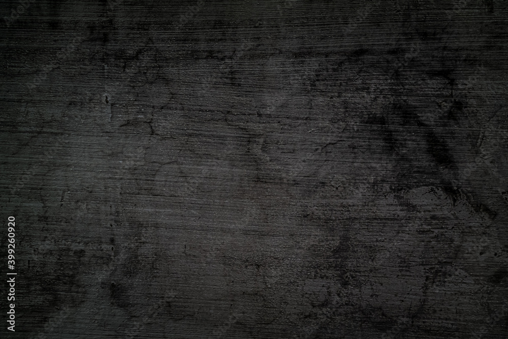 Rough, black-gray concrete wall background with crack and horizontal stripes.