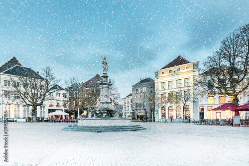 Winter view with snowfall of the central square in the historic Dutch city Deventer