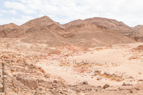 Desert  red mountains  rocks and cloudy sky. Egypt  color canyon.