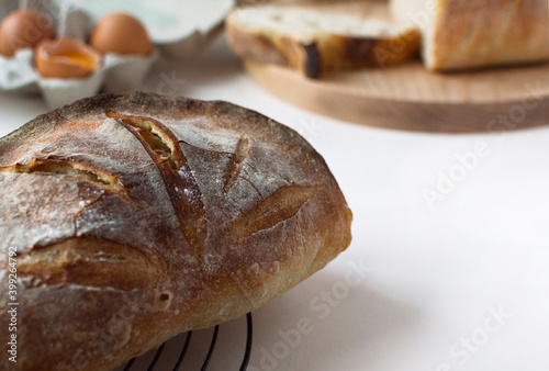 Fresh Homemade sourdough bread. Craft authentic french bread tabatière.  Home cooking. Concept of traditional leavened bread baking methods. Healthy food. Bread on cutting board. photo
