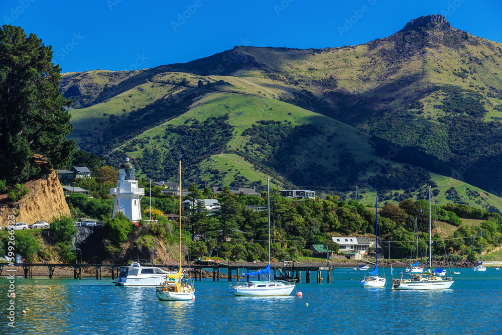 French Bay, Akaroa, New Zealand. The historic lighthouse on the left of the photo first operated in 1880