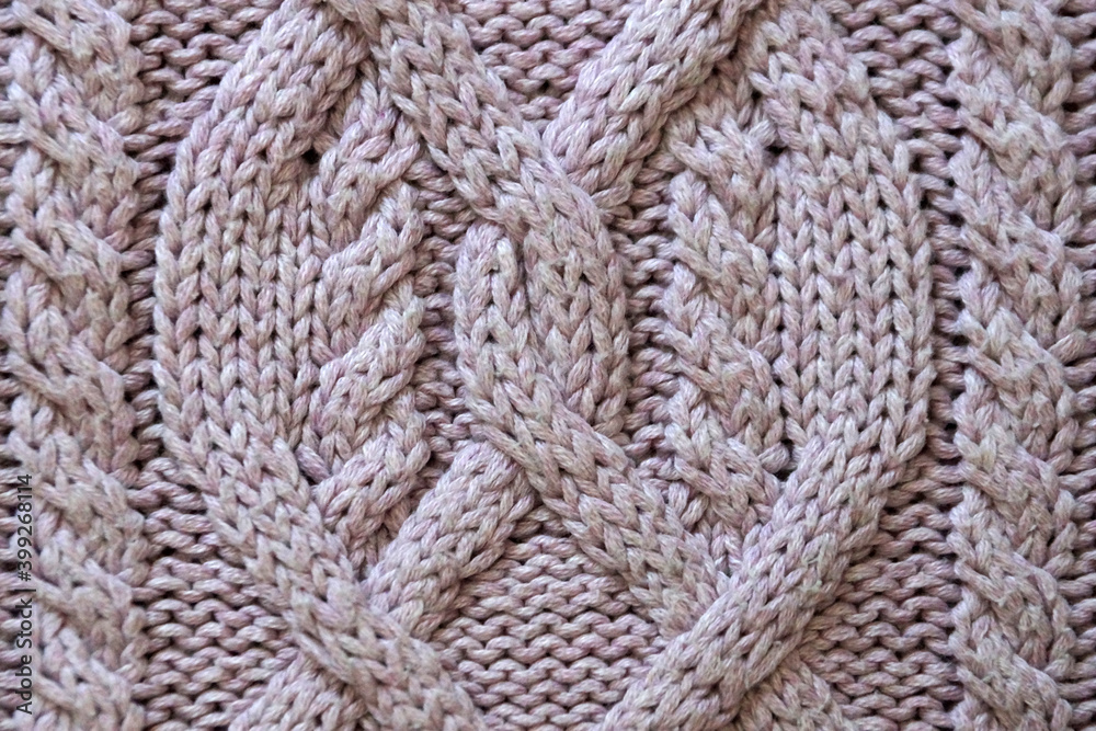 voluminous hand knitting close up for a pink background