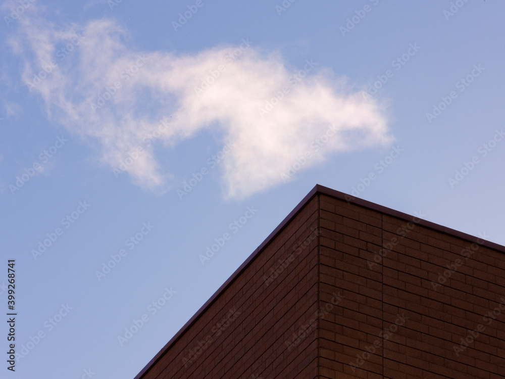 Corner of a building with blue sky beyond.