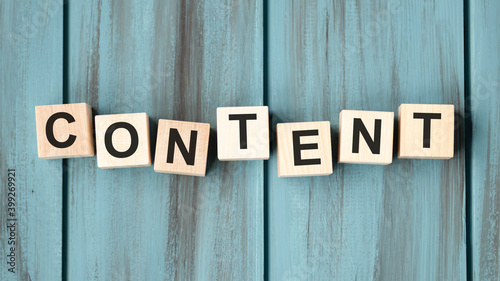 Wooden cubes with word CONTENT on blue table. Cubes with blue letters.