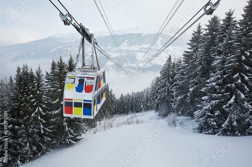 Skiing cabin lift above a valley, snowy winter landscape