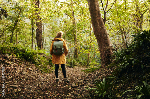 Woman standing in woodland