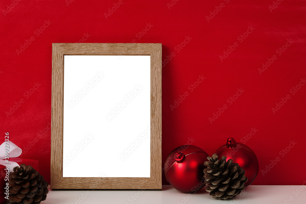 Blank wooden photo frame mockup template and christmas decoration on red blackground. - obrazy, fototapety, plakaty 