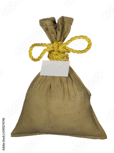 Gift bag tied with gold cord isolated on white background.