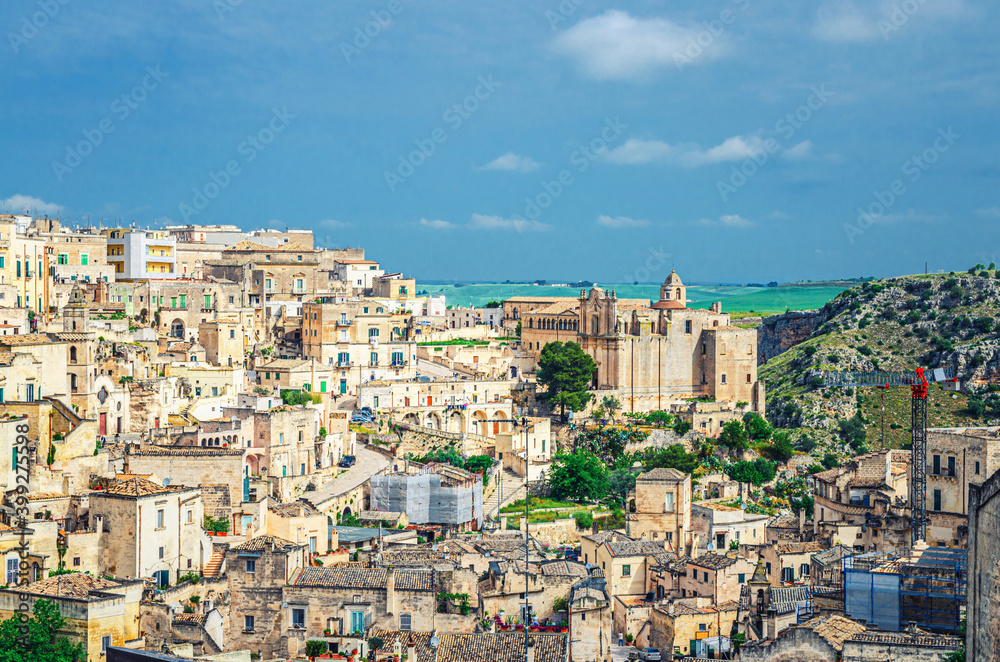Aerial panoramic view of Matera historical centre Sasso Barisano of old ancient town Sassi di Matera with rock cave houses and stone buildings, UNESCO World Heritage Site, Basilicata, Southern Italy