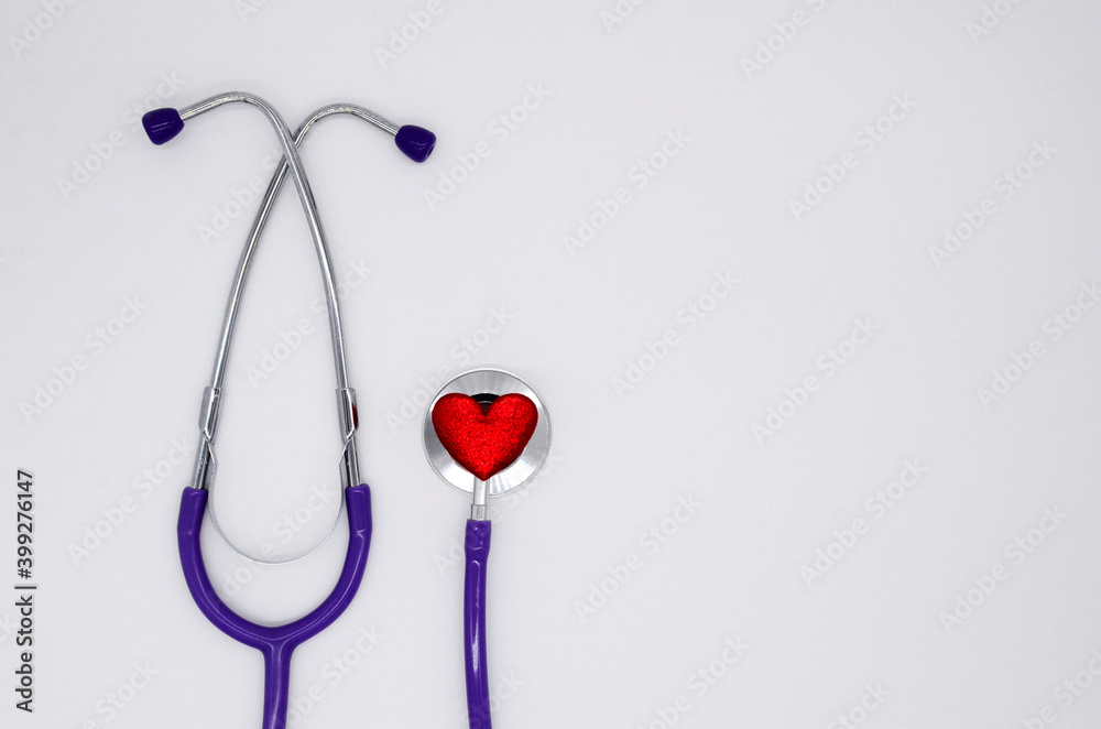 Stethoscope and red heart on white background with copy space. Medical Flatly. Cardiology. Concept of Valentines day.
