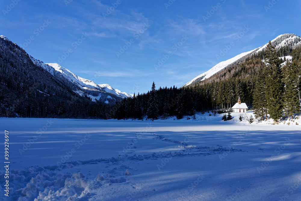 a small church in the snowy mountains