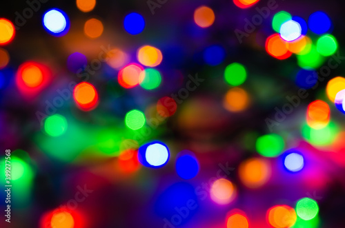 Abstract pattern of colorful bokeh lights on dark background