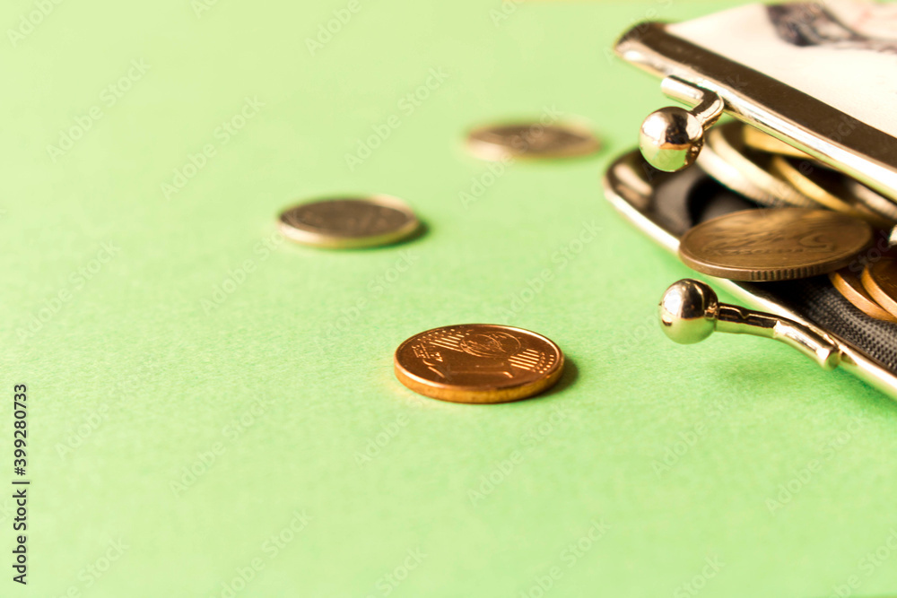 Wallet with coins on a light background. Close up. Selective focus. The concept of poverty. Wallet with coins on a light background. Close up. Selective focus. The concept of poverty.