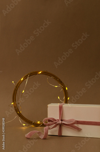 Vertical image.Shiny golden garland, wooden decorative ring and gift box for valentine`s day.Empty space