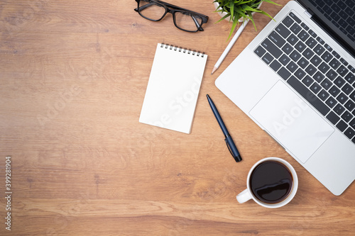 Workplace of office desk wooden table with laptop, and equipment other office supplies with copy space, flat lay