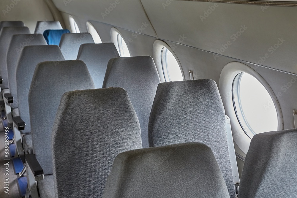 Fototapeta premium Empty rows of seats on an old plane