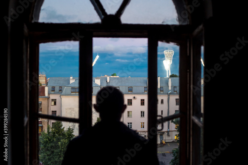 silhouette of a person on a balcony