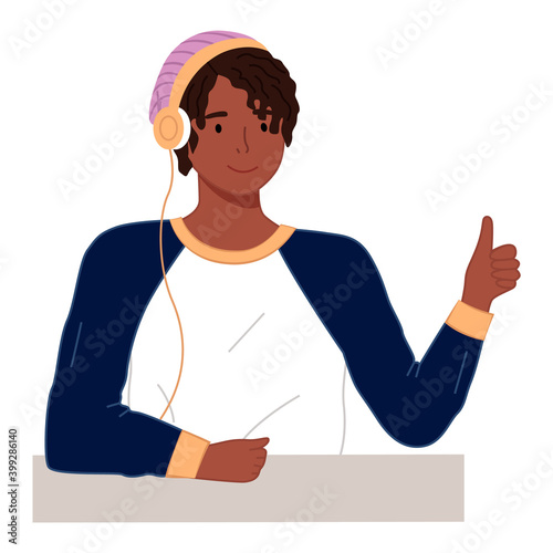 Happy young tanned man with headphones and pink knitted hat. Cartoon black guy close up. Young cheerful boy in sporty longsleeve. Man sitting and thumb up. Male with dreadlocks or curly hair
