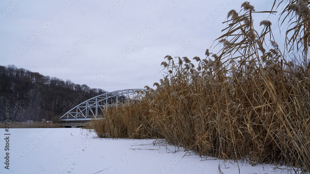 Iron bridge over the ice of the Voronezh reservoir in winter