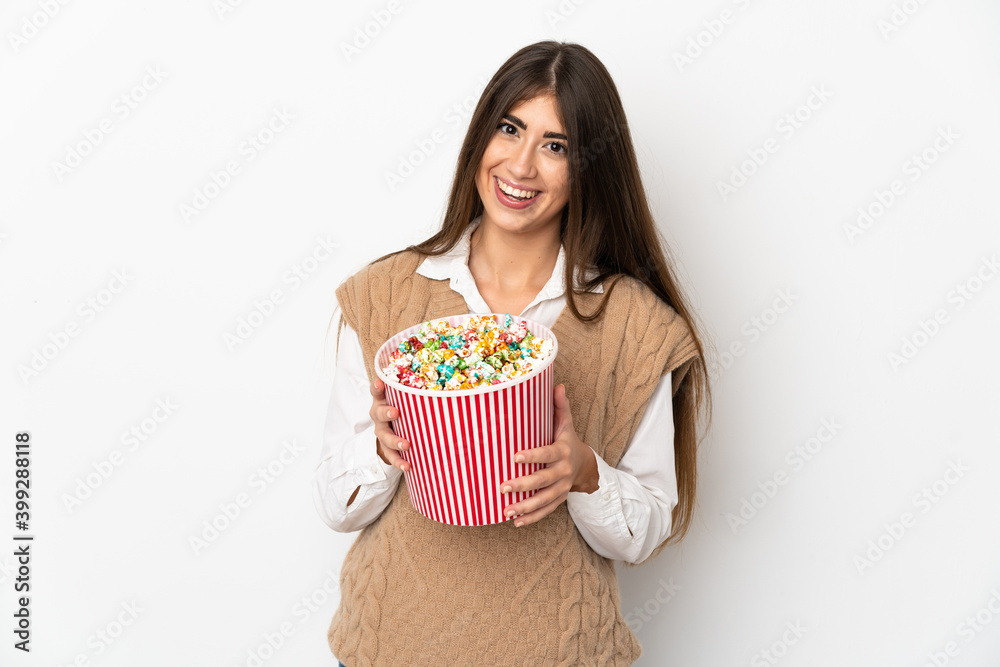 Young caucasian woman isolated on white background holding a big bucket of popcorns Young caucasian woman isolated on white background holding a big bucket of popcorns
