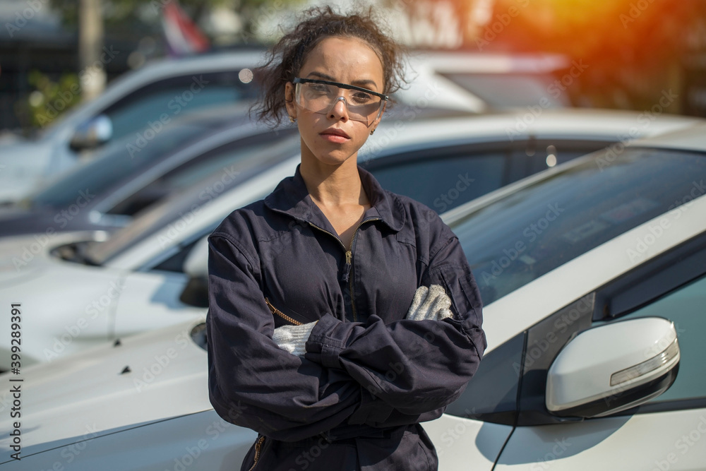 woman in a car mechanic stands to embrace her confidence in her career and succeed at the garage.