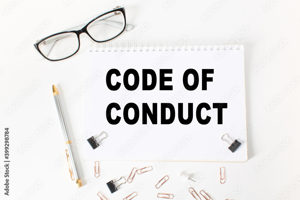 Notepad with inscriptions CODE OF CONDUCT on a white background. business concept. Notepad with inscriptions CODE OF CONDUCT on a white background. business concept.