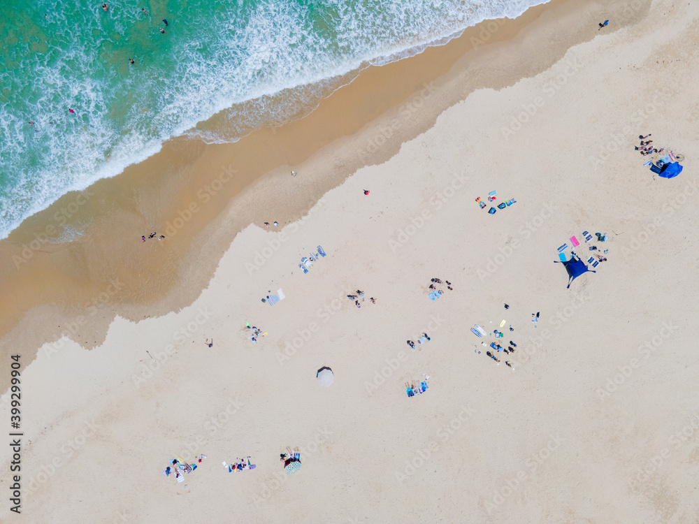 High angle view of people sunbathing on beach