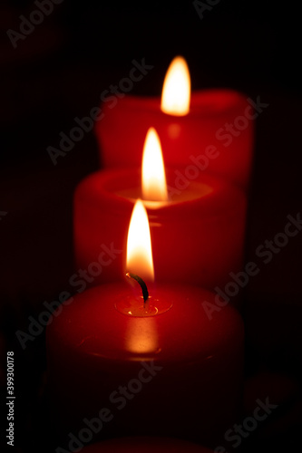 Flame red candles isolated on black background. Close up.