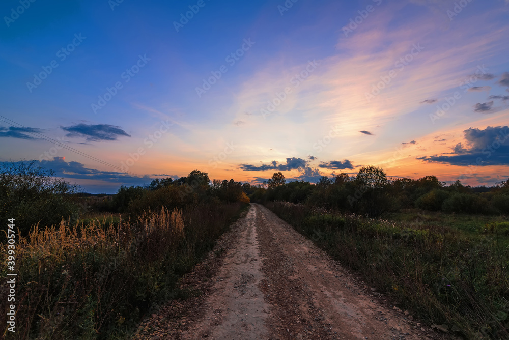 evening landscape with sunset over the road in autumn