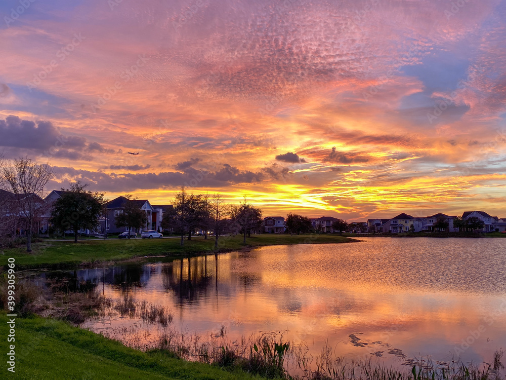 Fototapeta premium Beautiful pink, orange and blue sunset reflecting on a lake