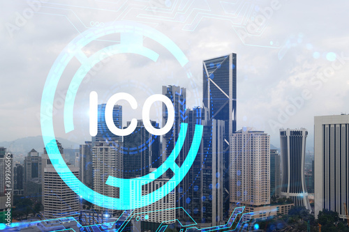 ICO icon hologram over panorama city view of Kuala Lumpur. KL is the hub of blockchain projects in Malaysia, Asia. The concept of initial coin offering. Double exposure.