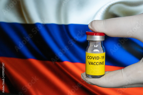 COVID-19 Pandemic Coronavirus concept. Russia Coronavirus vaccine, Sputnik V. Covid-19 vaccination, flu prevention, immunization concept with Russian Flag at background. Spoutnik V new russia vaccine.