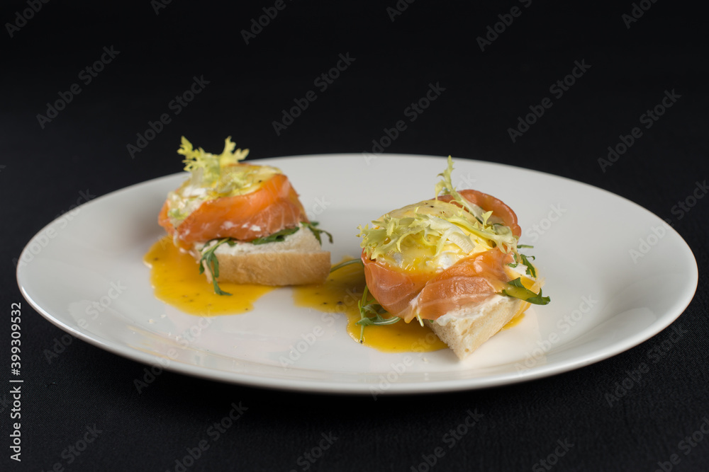 A delicious eggs benedict with lightly salted salmon and sauce.