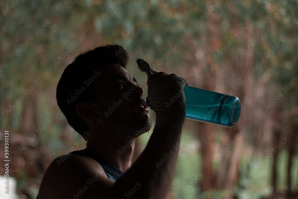 Fototapeta premium young athlete drinking water