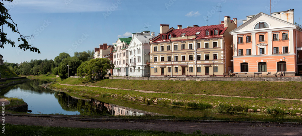 View of the old street by the river in the center of the city . Pskov, Russia