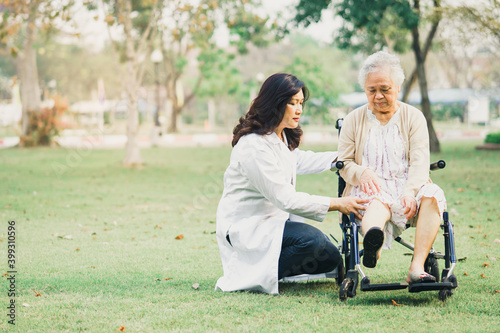 Fototapeta Naklejka Na Ścianę i Meble -  Doctor help and care Asian senior or elderly old lady woman patient sitting on wheelchair at park in nursing hospital ward, healthy strong medical concept.