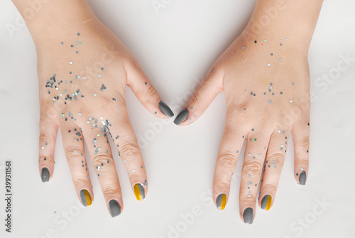 Female hand with trendy manicure in ultimate gray color. Color of the Year 2021.