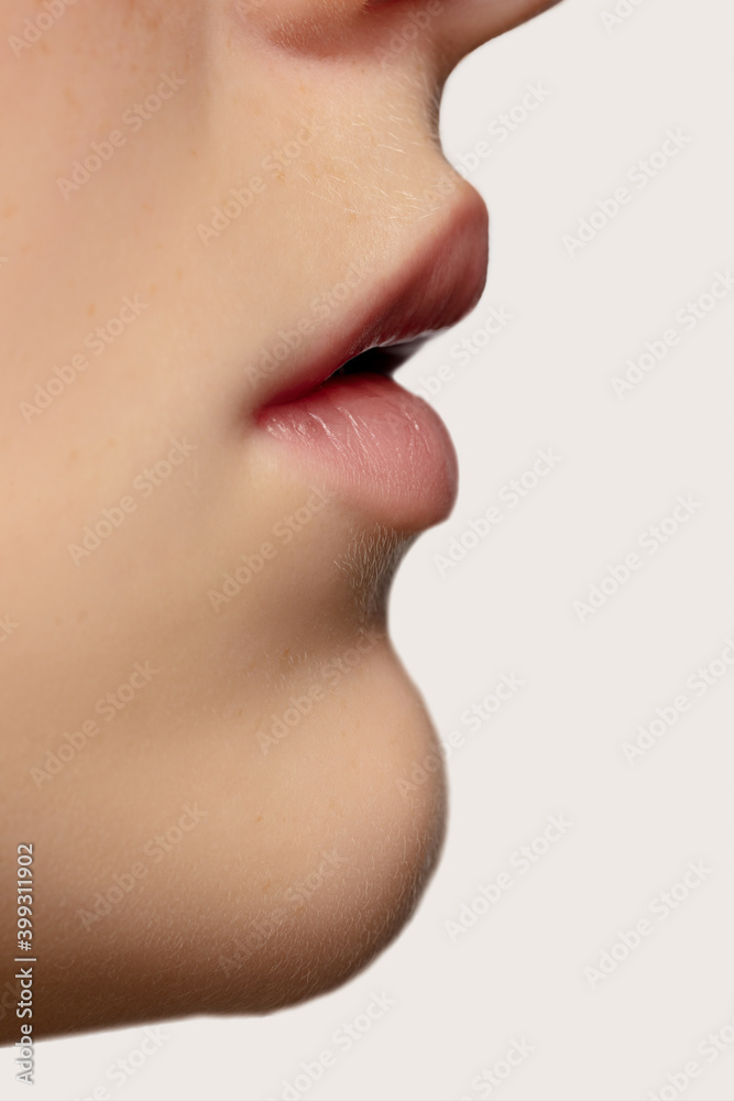 Profile lips. Close up portrait of beautiful redhair caucasian female model. Parts of face. Beauty, fashion, skincare, cosmetics, wellness concept. Copyspace. Well-kept skin, fresh look, details. Profile lips. Close up portrait of beautiful redhair caucasian female model. Parts of face. Beauty, fashion, skincare, cosmetics, wellness concept. Copyspace. Well-kept skin, fresh look, details.