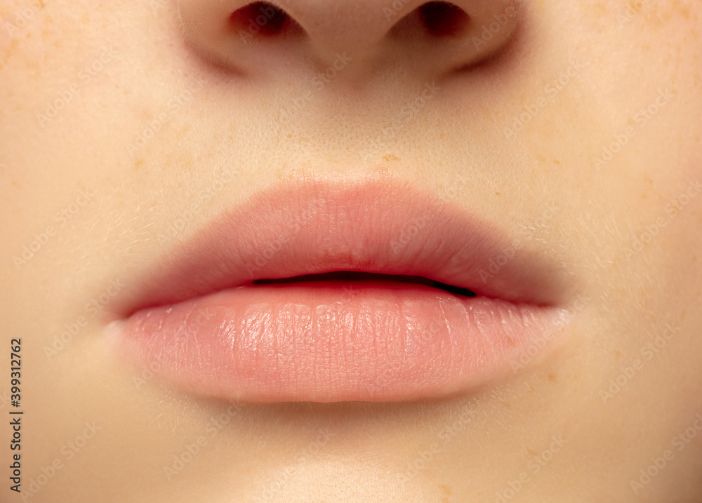 Lips. Close up portrait of beautiful redhair caucasian female model. Parts of face. Beauty, fashion, skincare, cosmetics, wellness concept. Copyspace. Well-kept skin, fresh look, details. Lips. Close up portrait of beautiful redhair caucasian female model. Parts of face. Beauty, fashion, skincare, cosmetics, wellness concept. Copyspace. Well-kept skin, fresh look, details.