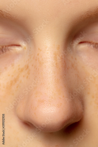 Nose and cheeks. Close up portrait of beautiful redhair caucasian female model. Parts of face. Beauty, fashion, skincare, cosmetics, wellness concept. Copyspace. Well-kept skin, fresh look, details.