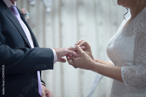 close-up of a couple wearing their ring on their silver wedding anniversary
