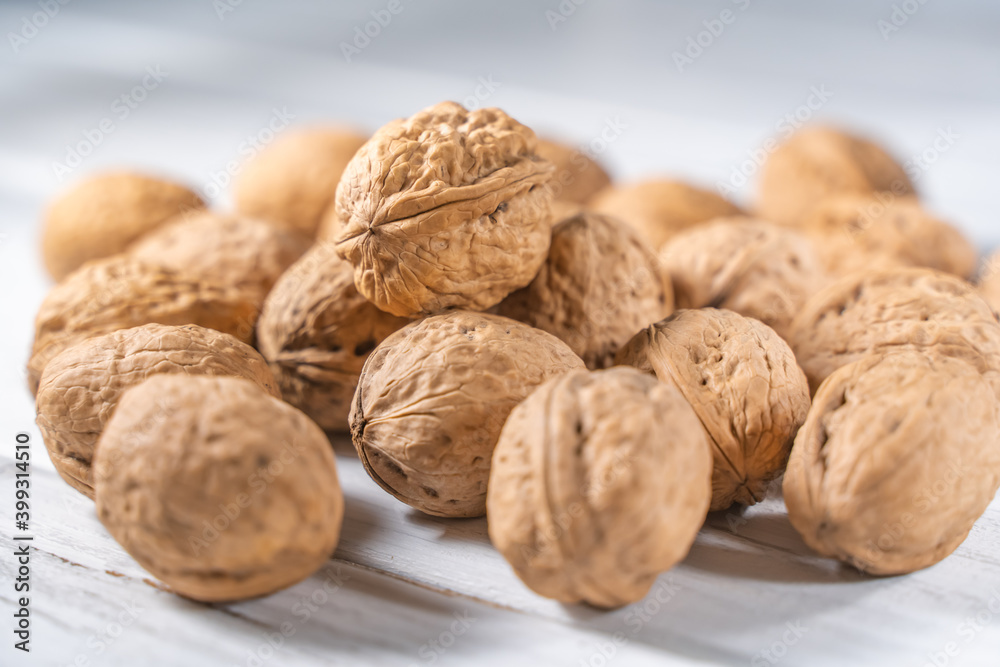 Walnuts kernels on white wooden desk, stock photo Walnuts kernels on white wooden desk, stock photo