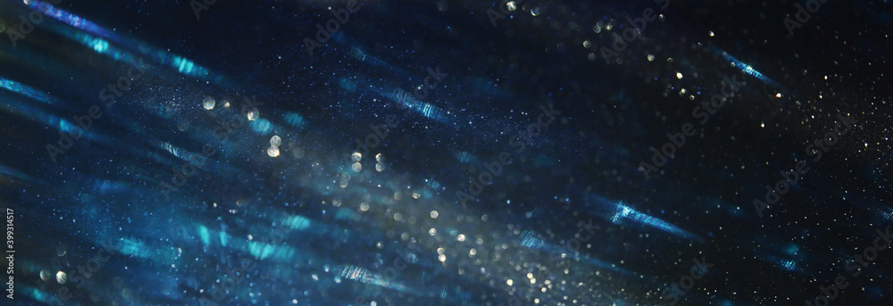 background of abstract glitter lights. Gold ,blue and black. de focused