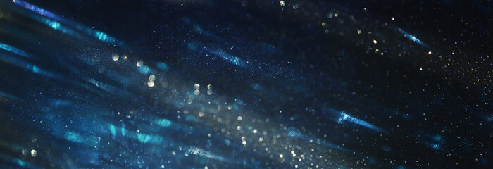 background of abstract glitter lights. Gold ,blue and black. de focused