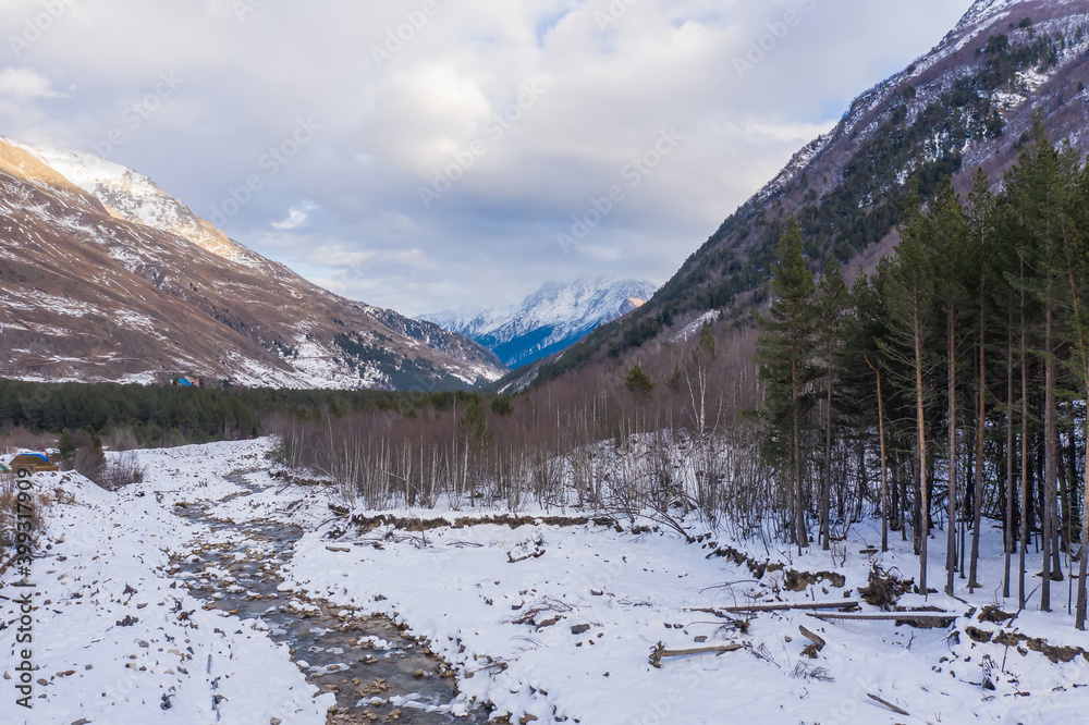 Fototapeta premium Aerial view of the winter mountain river in the Cheget valley