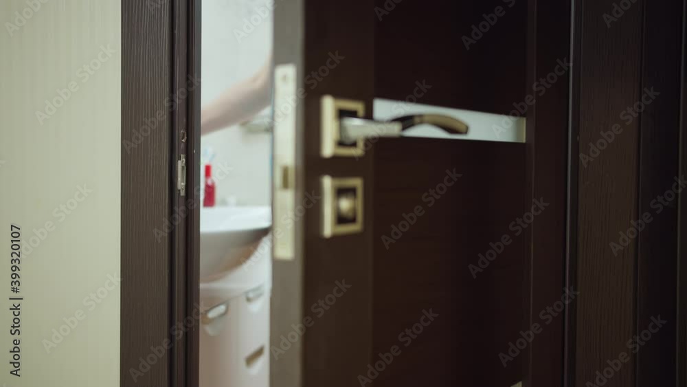 Man enters the bathroom washing his hands, hand hygiene Man enters the bathroom washing his hands, hand hygiene